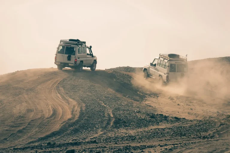 Cars driving in dusty desert