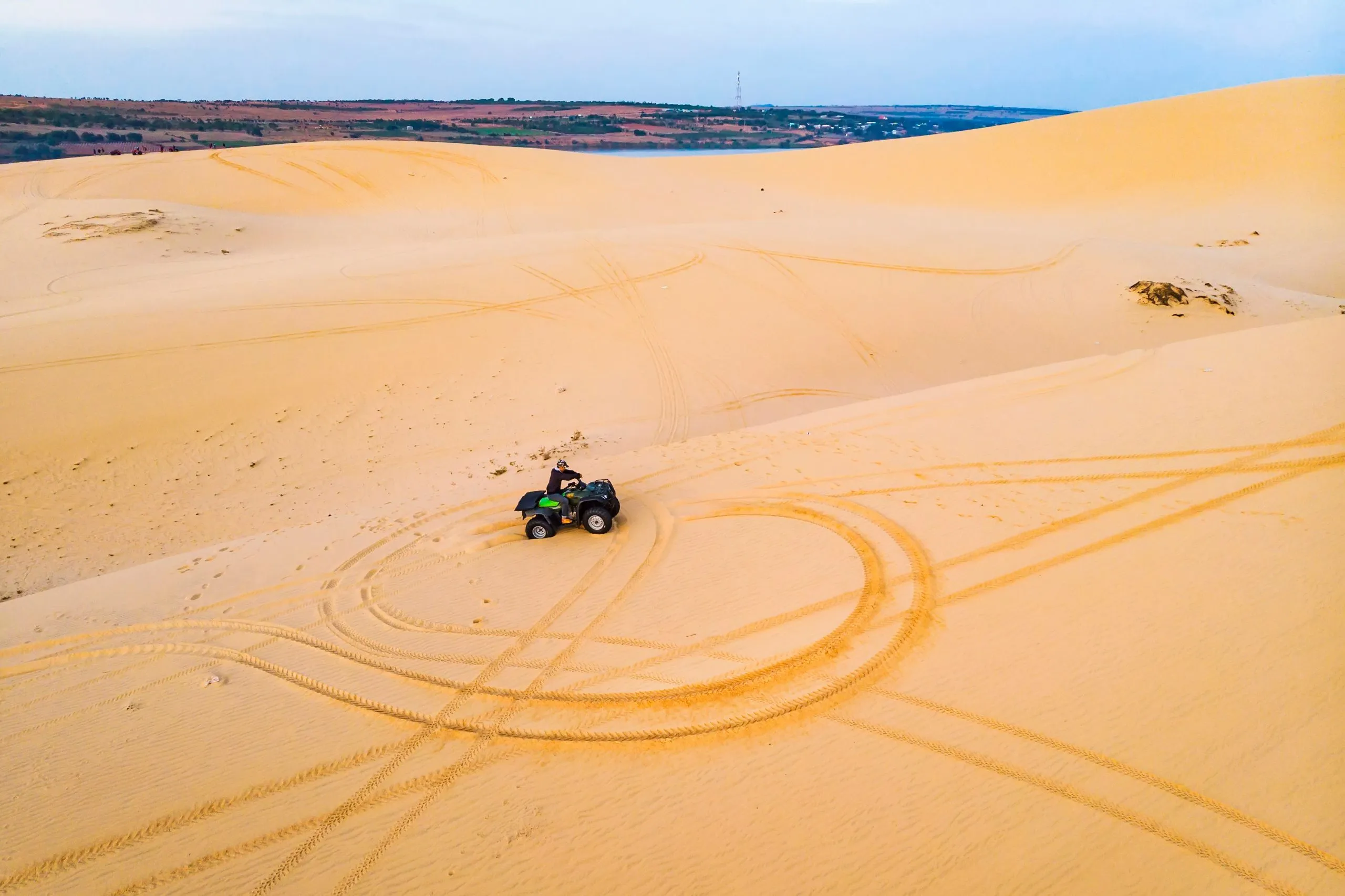 Quad driving people - happy bikers in sand desert