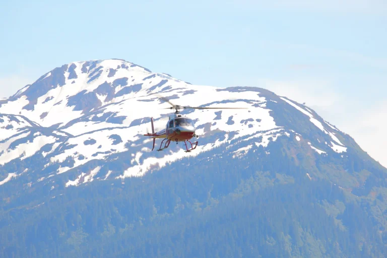 helicopter flies in front of glacial peak stockpack adobe stock scaled